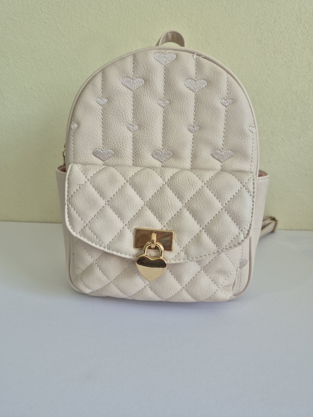 Under One Sky Cream Quilted Backpack with Gold Heart Lock
